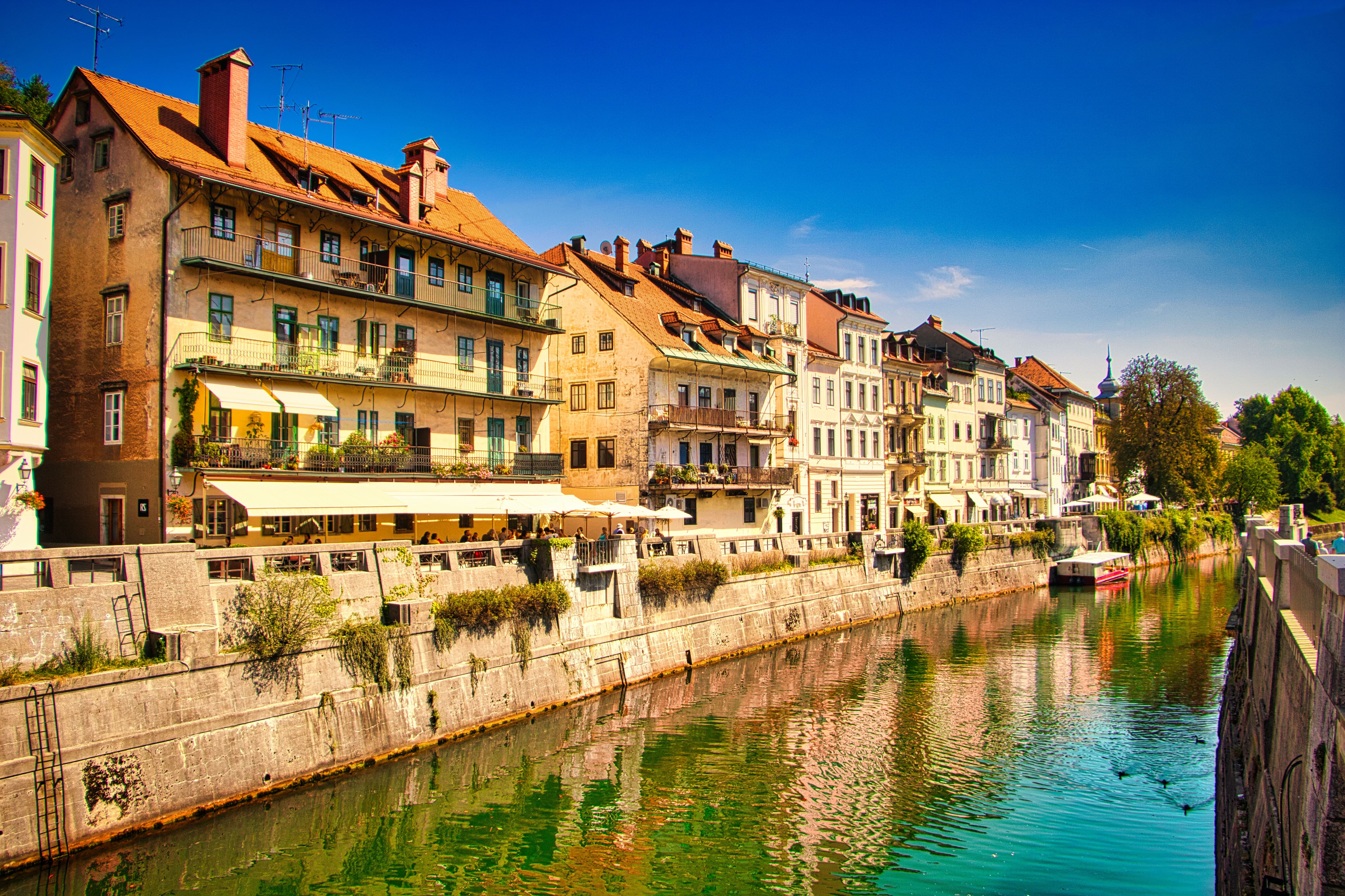 white and brown concrete buildings beside river during daytime