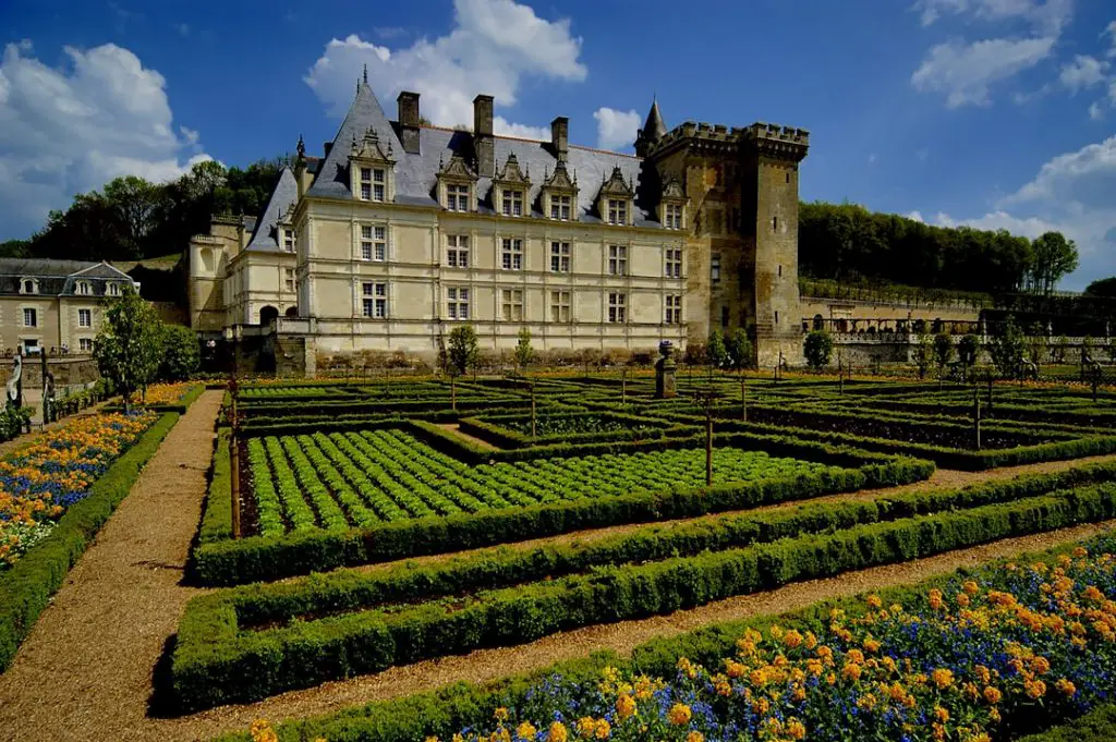 a large building with a garden in front of it